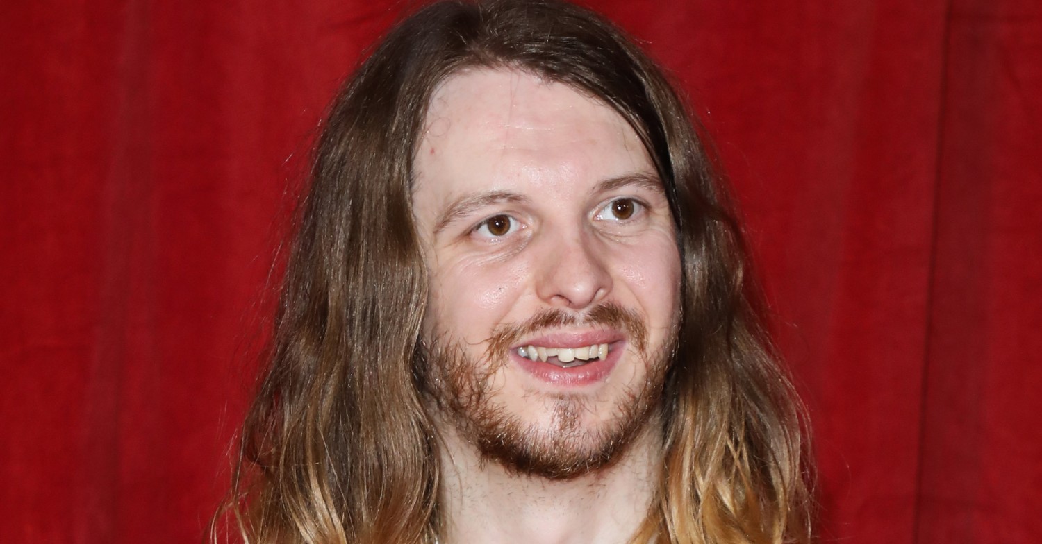 James Moore smiles on the red carpet (Credit: SplashNews.com)