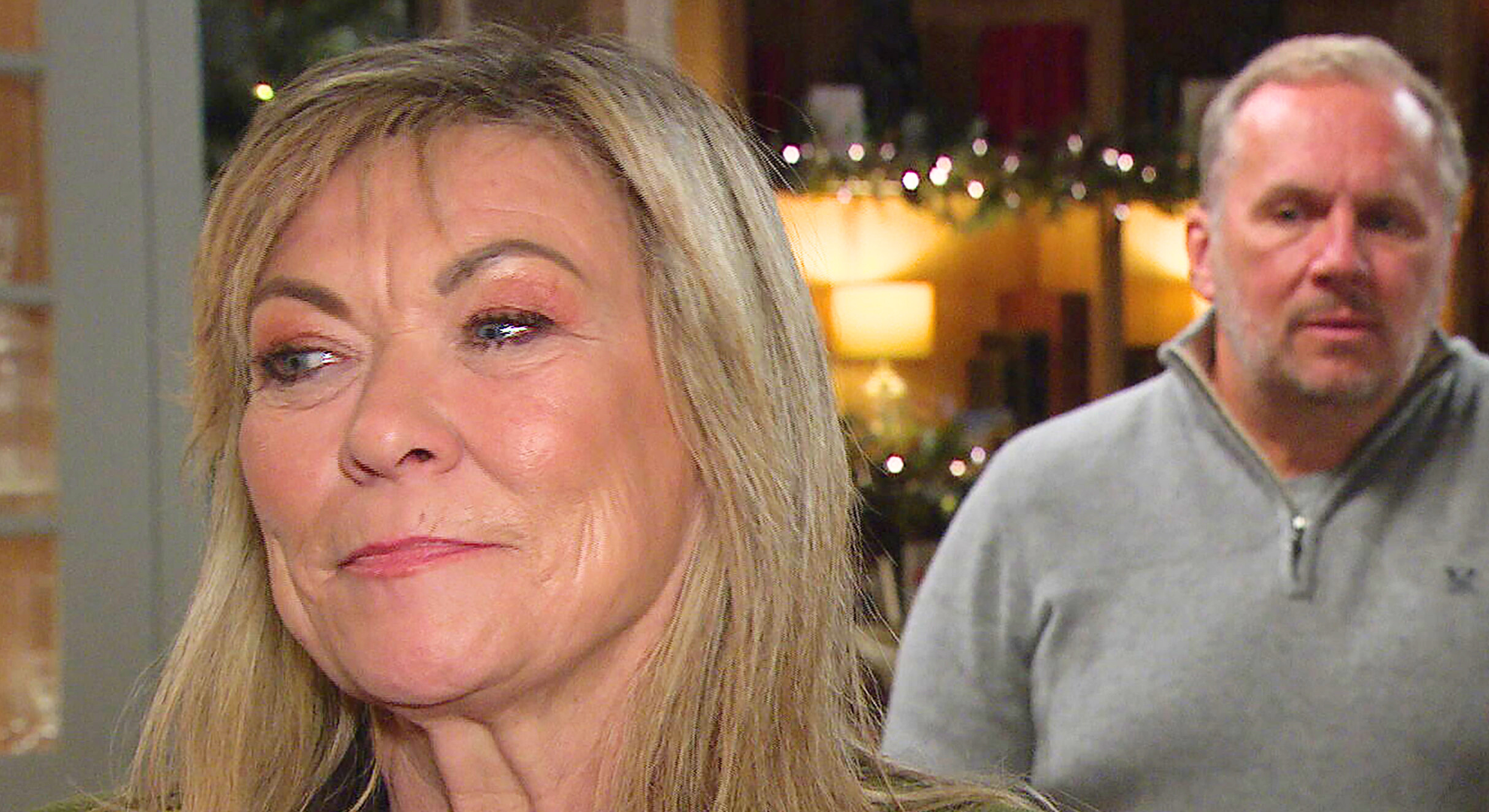 Kim Tate smiles with Will Taylor behind her (Credit: ITV/Comp Emmerdale Insider)